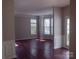 Sunlit living room with hardwood floors, large windows, and neutral paint, creating a welcoming ambiance at 7731 Harrington Woods Rd # 17, Charlotte, NC 28269