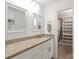 Bathroom features a granite countertop, storage space below, and walk-in closet accessibility at 8412 Cricket Lake Dr, Charlotte, NC 28277
