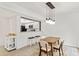 Dining area boasts modern light fixture, bar seating and white cabinetry at 8412 Cricket Lake Dr, Charlotte, NC 28277