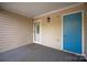 Covered front porch with decorative sconce and blue door at 8412 Cricket Lake Dr, Charlotte, NC 28277