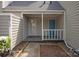 Charming covered front porch with white railing and blue door at 8412 Cricket Lake Dr, Charlotte, NC 28277