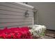 Up close exterior shot with colorful flowering shrubs and sconce at 8412 Cricket Lake Dr, Charlotte, NC 28277