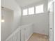 Hallway view boasts neutral carpeting and three large windows at 8412 Cricket Lake Dr, Charlotte, NC 28277