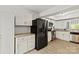 Bright kitchen boasts stainless steel appliances and white cabinetry at 8412 Cricket Lake Dr, Charlotte, NC 28277