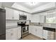 Updated kitchen features stainless steel appliances, granite countertops, and white cabinetry at 8412 Cricket Lake Dr, Charlotte, NC 28277