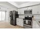 Updated kitchen features stainless steel appliances, granite countertops, and white cabinetry at 8412 Cricket Lake Dr, Charlotte, NC 28277