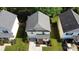 Aerial view of a well-maintained lawn, asphalt driveway, and single-car garage at 8829 Michaw Ct, Charlotte, NC 28269