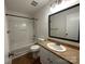 A full bathroom features wood grain floors, a bath/shower and vanity with a mirror at 8829 Michaw Ct, Charlotte, NC 28269