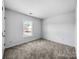 Bedroom with neutral carpet and a bright window at 8829 Michaw Ct, Charlotte, NC 28269