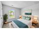 Staged bedroom with soft blue decor and a large window at 8829 Michaw Ct, Charlotte, NC 28269