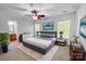 Stylishly staged bedroom with large windows, plush bedding, and modern decor at 8829 Michaw Ct, Charlotte, NC 28269
