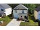 Exterior view of a two-story home with a lawn, driveway, and trees at 8829 Michaw Ct, Charlotte, NC 28269