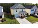 Exterior view of a two-story home with a lawn, driveway, and trees at 8829 Michaw Ct, Charlotte, NC 28269