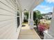 Inviting view down the covered front porch featuring colorful landscaping and a sidewalk at 8829 Michaw Ct, Charlotte, NC 28269