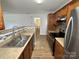 Galley kitchen featuring stainless appliances and tile backsplash at 8829 Michaw Ct, Charlotte, NC 28269