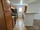 Galley kitchen with stainless steel appliances and wood cabinets at 8829 Michaw Ct, Charlotte, NC 28269