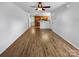 Expansive living room featuring hardwood floors, a fan, and an adjacent kitchen at 8829 Michaw Ct, Charlotte, NC 28269