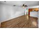 Spacious living room with hardwood floors, a ceiling fan, and a view into the kitchen at 8829 Michaw Ct, Charlotte, NC 28269