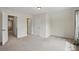 Bright, neutrally painted bedroom with carpeted floor and doorway leading to the bathroom at 8923 Happiness Rd, Harrisburg, NC 28075