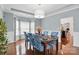Dining room with wood floors, wainscoting, and a large window to provide ample natural light at 8923 Happiness Rd, Harrisburg, NC 28075
