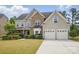 Charming home with a two-car garage, well-manicured lawn, and lush landscaping at 8923 Happiness Rd, Harrisburg, NC 28075