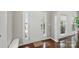 Bright foyer featuring hardwood floors, white trim, and a sidelight at 8923 Happiness Rd, Harrisburg, NC 28075
