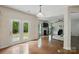 Open-concept living room features hardwood floors, fireplace, and double glass doors to the backyard at 8923 Happiness Rd, Harrisburg, NC 28075