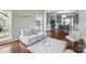 Open-concept living room with hardwood floors and views to the dining room at 8923 Happiness Rd, Harrisburg, NC 28075