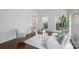 Bright living room with hardwood floors, a gray sofa and chairs, and many windows at 8923 Happiness Rd, Harrisburg, NC 28075