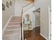 Elegant staircase with carpeted steps and a white railing at 8923 Happiness Rd, Harrisburg, NC 28075