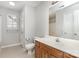 Bathroom with a wood vanity, a large mirror, and neutral-toned walls and floor at 9419 Isaac Hunter Dr, Charlotte, NC 28214