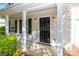 Close-up of the front door, framed by sidelights, exterior lighting, and a covered porch at 9419 Isaac Hunter Dr, Charlotte, NC 28214