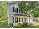 Charming two-story home featuring a well-maintained yard and inviting front porch with black accents and white trim at 9419 Isaac Hunter Dr, Charlotte, NC 28214