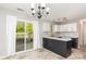 Well-lit kitchen with a sliding glass door leading to a deck; modern appliances and ample countertop space at 9419 Isaac Hunter Dr, Charlotte, NC 28214