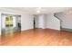 Bright open-concept living room showcasing hardwood floors, neutral walls, and seamless flow into the adjacent kitchen area at 9419 Isaac Hunter Dr, Charlotte, NC 28214