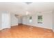 Spacious living room with hardwood floors, a ceiling fan, and plenty of natural light from multiple windows at 9419 Isaac Hunter Dr, Charlotte, NC 28214