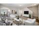 Virtually staged living room with a comfortable seating area and open access to the kitchen and stairway at 9419 Isaac Hunter Dr, Charlotte, NC 28214