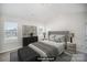 Virtually staged main bedroom featuring soft grey tones, a plush bed, and lots of natural light at 9419 Isaac Hunter Dr, Charlotte, NC 28214