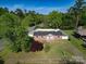 Aerial view of a brick home with a fenced yard, surrounded by lush greenery at 1005 Clarkson St, Rock Hill, SC 29730