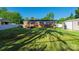 Spacious backyard featuring a lush lawn, brick home, storage shed, and white picket fence at 1005 Clarkson St, Rock Hill, SC 29730