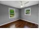 Bedroom featuring hardwood floors, a ceiling fan, and large windows at 1005 Clarkson St, Rock Hill, SC 29730