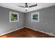 Bedroom with hardwood floors, neutral walls, ceiling fan and two windows at 1005 Clarkson St, Rock Hill, SC 29730