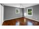 Bedroom featuring hardwood floors, neutral walls, and two windows at 1005 Clarkson St, Rock Hill, SC 29730