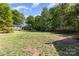Spacious backyard with trees and grass at 103 Woodwinds St, Locust, NC 28097