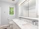 Updated bathroom with double sink vanity with marble countertop, and large mirror at 103 Woodwinds St, Locust, NC 28097