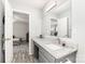 Bathroom with grey vanity featuring granite countertop, stainless steel faucet and hardware at 103 Woodwinds St, Locust, NC 28097
