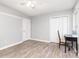 Bright bedroom with a fan, light gray walls, and wood-look floors, closet, and white door at 103 Woodwinds St, Locust, NC 28097