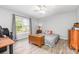 Bedroom featuring a large window, hardwood floors and ceiling fan for a bright and airy atmosphere at 103 Woodwinds St, Locust, NC 28097