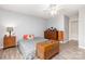Cozy bedroom with hardwood floors, ceiling fan, and vintage wood accents for a warm, inviting feel at 103 Woodwinds St, Locust, NC 28097