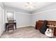 Bedroom featuring wood-look floors, white trim, and a window letting in natural light at 103 Woodwinds St, Locust, NC 28097